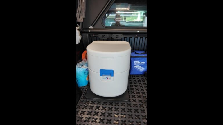 Joolca GottaGo portable camping toilet mounted on TMAT cargo mat in truck bed